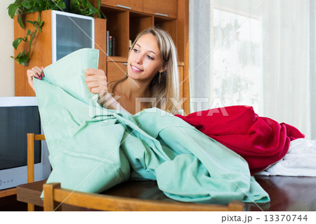 Woman looking at new curtains 13370744