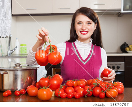 Happy woman with red tomatoes Happy woman with red tomatoes 13370797