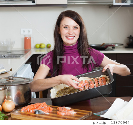 happy woman cooking fish pie with salmon happy woman cooking fish pie with salmon 13370944