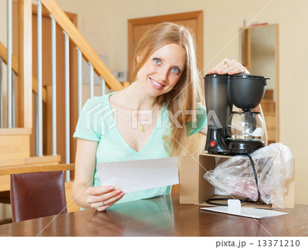 Woman with new electric coffee maker Woman with new electric coffee maker 13371210
