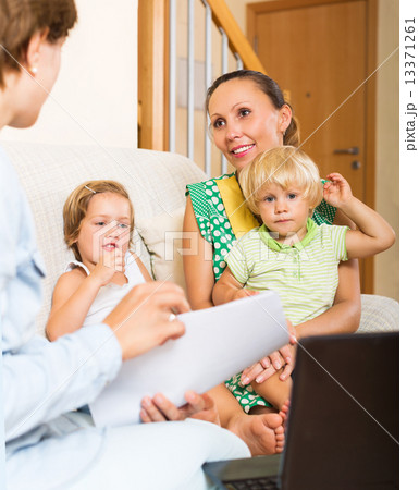 Satisfied mother arranging mortgage details 13371261
