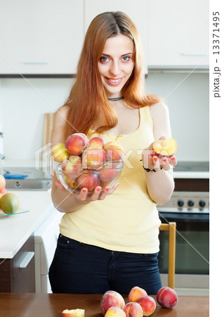 Women holding peaches as breasts