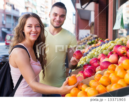 Happy couple picking fruits 13371903