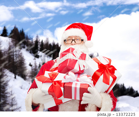 man in costume of santa claus with gift boxes man in costume of santa claus with gift boxes 13372225