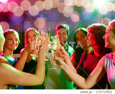 smiling friends with wine glasses and beer in club smiling friends with wine glasses and beer in club 13372902