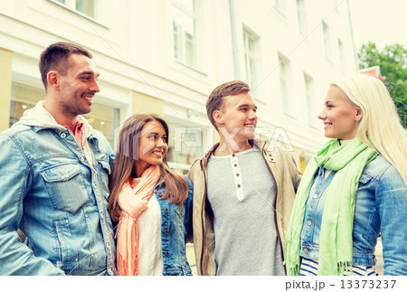 group of smiling friends walking in the city group of smiling friends walking in the city 13373237