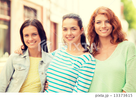 smiling teenage girls with on street 13373615