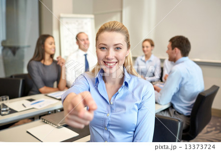 group of smiling businesspeople meeting in office group of smiling businesspeople meeting in office 13373724