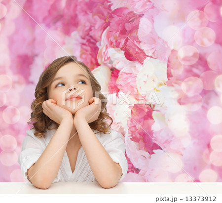 beautiful girl sitting at table and looking up 13373912