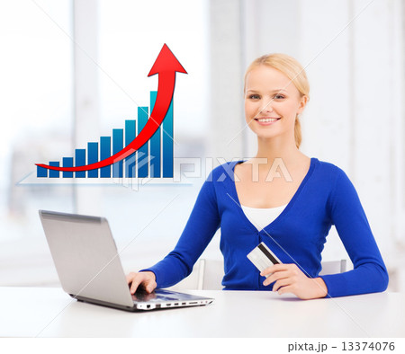 smiling woman with laptop computer and credit card 13374076