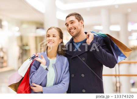 happy young couple with shopping bags in mall happy young couple with shopping bags in mall 13374320