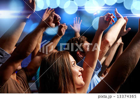 smiling friends at concert in club 13374365
