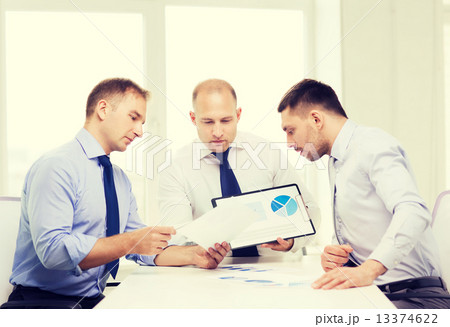 serious businessmen with papers in office serious businessmen with papers in office 13374622