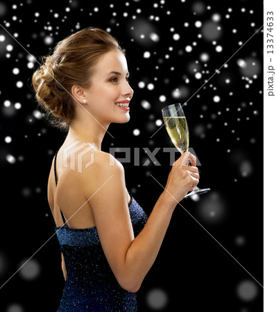 smiling woman holding glass of sparkling wine smiling woman holding glass of sparkling wine 13374633