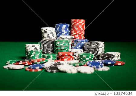 close up of casino chips on green table surface close up of casino chips on green table surface 13374634