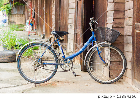 Old bike in front of the wooden wall at home Old bike in front of the wooden wall at home 13384266
