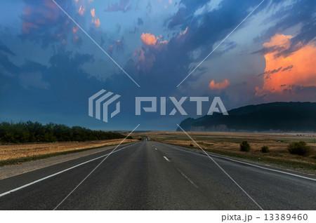 evening road under dramatic sky evening road under dramatic sky 13389460