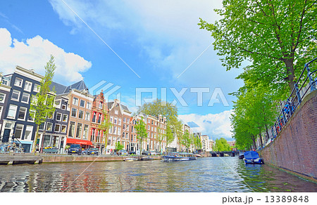 Traditional Houses and house boat along canal in Amsterdam Traditional Houses and house boat along canal in Amsterdam 13389848