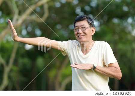 One male chinese elderly doing morning exercise in a park One male chinese elderly doing morning exercise in a park 13392926