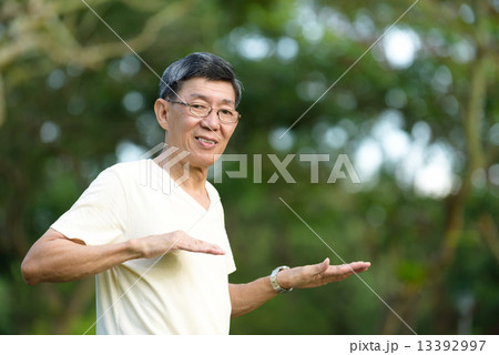 One male chinese elderly doing morning exercise in a park One male chinese elderly doing morning exercise in a park 13392997