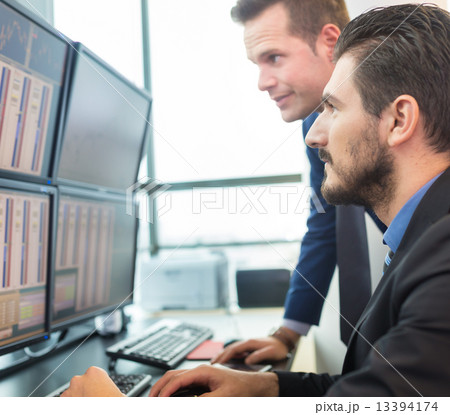 Stock traders looking at computer screens. Stock traders looking at computer screens. 13394174