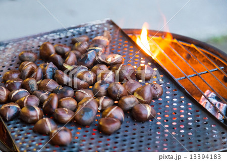 Grilling chestnuts. 13394183
