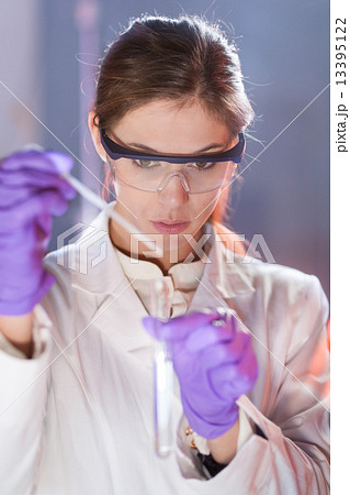 Young scientist pipetting. 13395122
