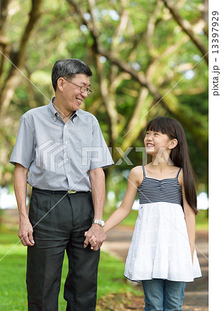 Chinese granddaughter and grandfather having a walk in the park Chinese granddaughter and grandfather having a walk in the park 13397929