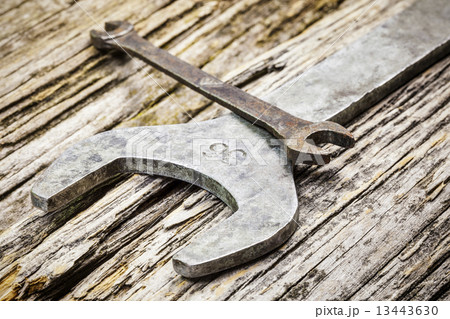 Old metallic spanners on wooden table  13443630