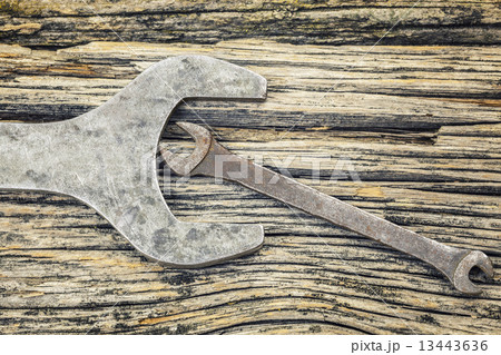 Vintage metallic spanners on old wooden table  13443636