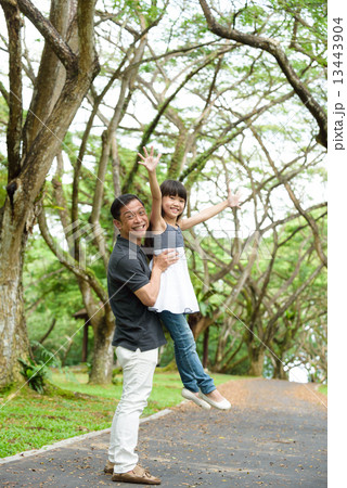 Chinese father and daughter playing in the park 13443904