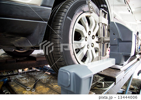 Automobile wheels alignment with focus on the wheel and equipment 13444006