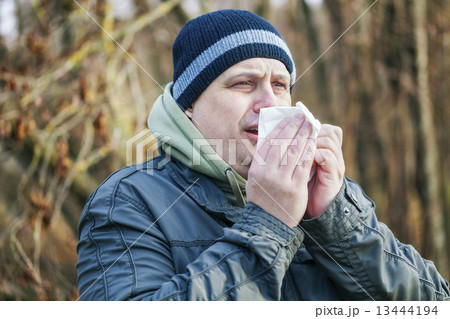 Man with napkin going to sneeze  13444194