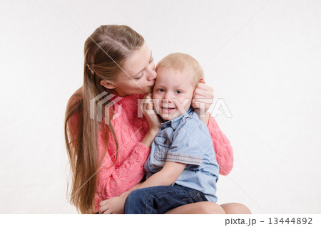 Young mother kissing her son three years Young mother kissing her son three years 13444892