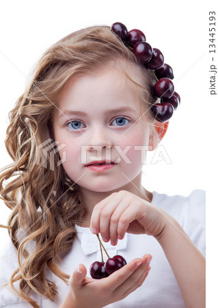 Freckled girl with cherries posing at camera 13445193