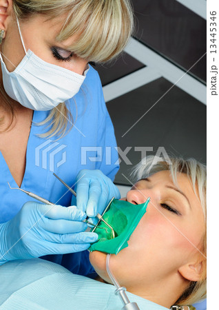 dentist with patient, cleaning and curing dentist with patient, cleaning and curing 13445346