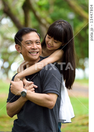 Chinese father and daughter having fun in the park 13447804