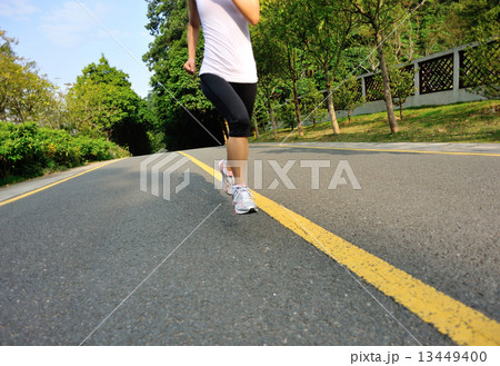 fitness woman running at forest road fitness woman running at forest road 13449400