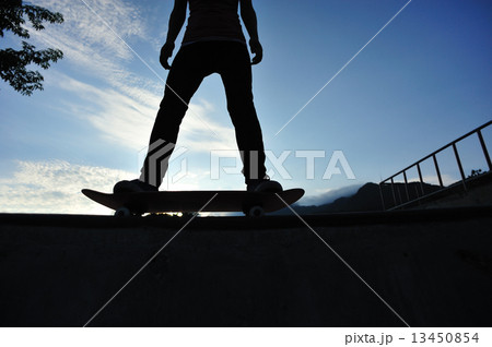 skateboarding woman at sunrise skatepark  13450854