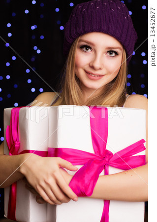 Beautiful teenager holding gift box with ribbon 13452677