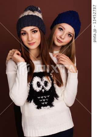 Two teenager girls friends in winter clothes  13452787
