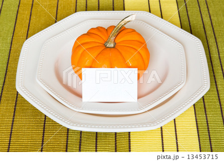 Autumn Thanksgiving dinner table setting with decorative pumpkin Autumn Thanksgiving dinner table setting with decorative pumpkin 13453715