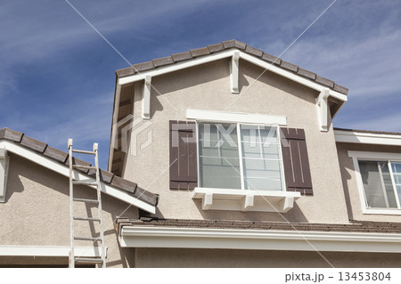 Ladder Leaning Up Against A Freshly Painted Home 13453804