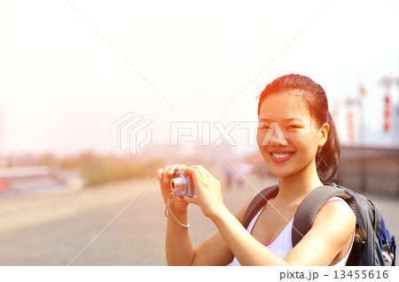 young asian woman tourist taking photo at the ancient city wall in xian,china young asian woman tourist taking photo at the ancient city wall in xian,china 13455616