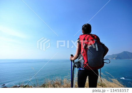 hiking woman stand under blue sky looking at the view hiking woman stand under blue sky looking at the view 13458357