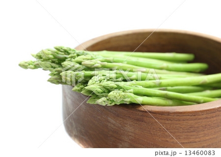 Asparagus on wood bowl isolated in white background Asparagus on wood bowl isolated in white background 13460083