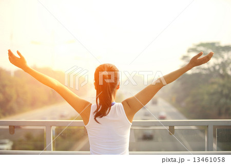 strong confident woman stand at the pedestrian overpass open arms to the rush driveway in modern cit strong confident woman stand at the pedestrian overpass open arms to the rush driveway in modern cit 13461058