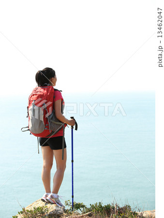 hiking woman stand seaside mountain rock looking at the view  13462047