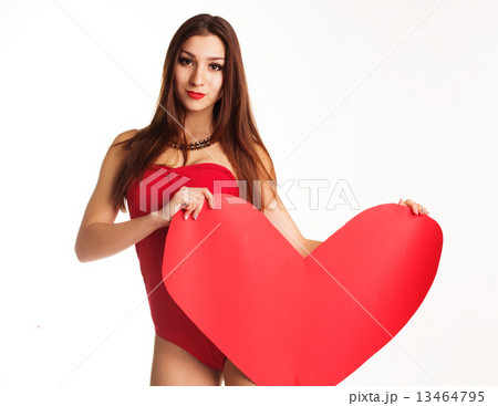 Beautiful girl in red bodi holding paper heart 13464795