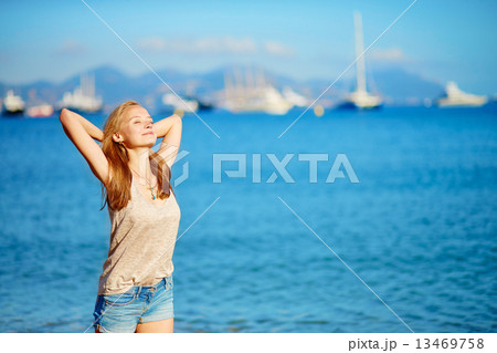 Young girl enjoying her vacation by the sea Young girl enjoying her vacation by the sea 13469758